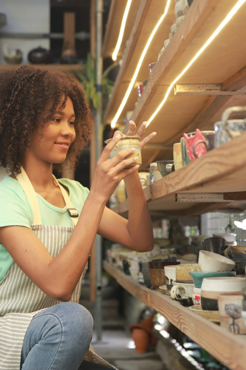 Young Woman hand potter making clay vase in pottery workshop, Business owner.